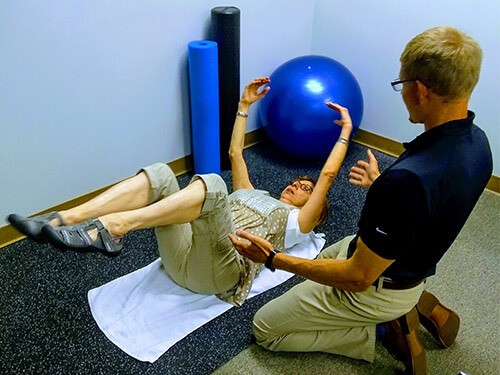 Image of Dr. Lederman instructing a patient through the dead bug exercise